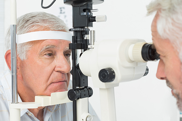 Close-up of an optometrist doing sight testing for senior patient