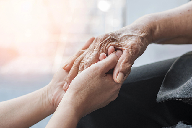 Senior woman receiving personal care from Right at Home franchise caregiver