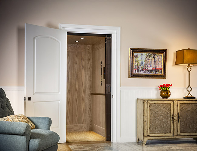 Residential home elevator with a light wood interior providing accessible mobility for aging in place
