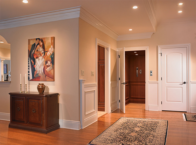 Residential hallway with a built-in home elevator designed to support safe aging in place