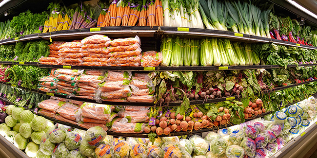 Vegetable shelves inside a modern Whole Foods Market grocery store.