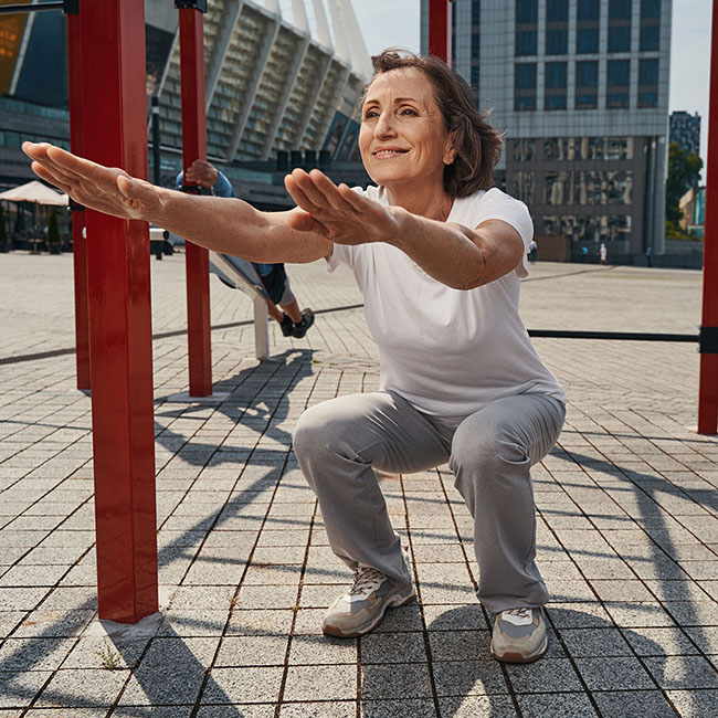 Active older adult performing a functional fitness exercise to improve strength, balance, and mobility.