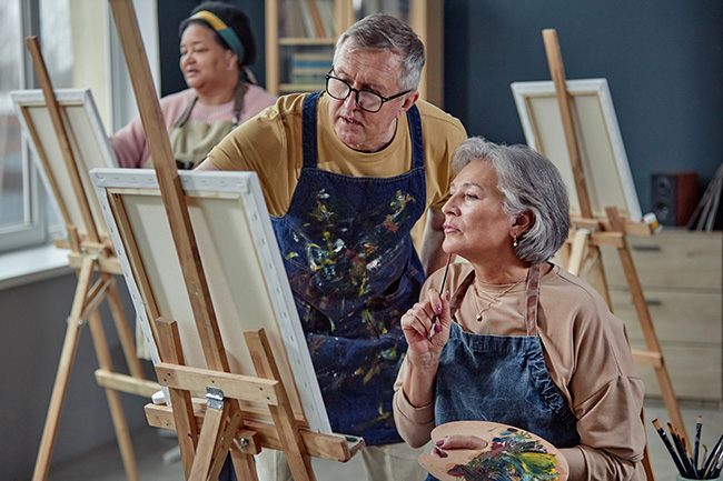 Adults participating in a community art class and building social connections through a shared interest.