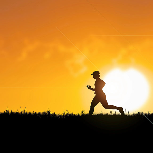 Older adult running outdoors at sunset