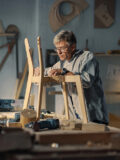 Older man working on a woodworking project in his workshop