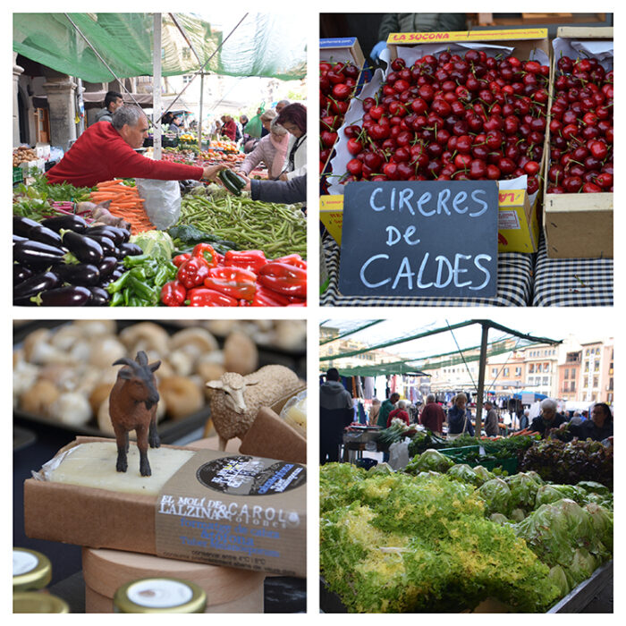 Traditional outdoor market in Vic, Spain, featuring fresh produce, local cheeses, and market vendors